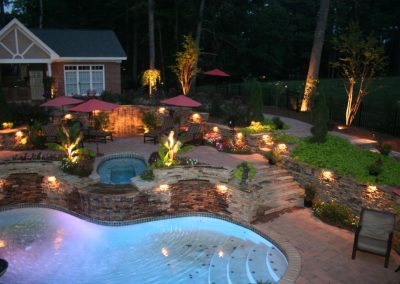 Image of backyard with accent lighting.
